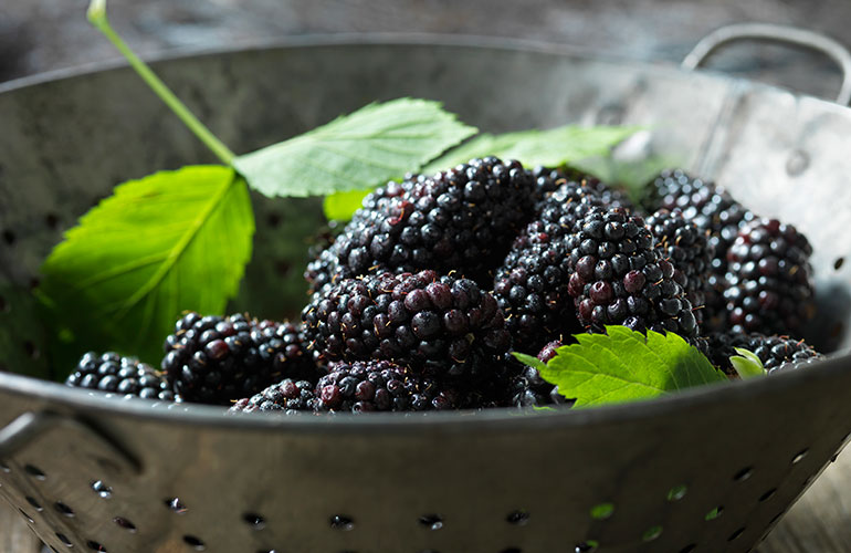 Use colanders to keep berries and grapes fresh