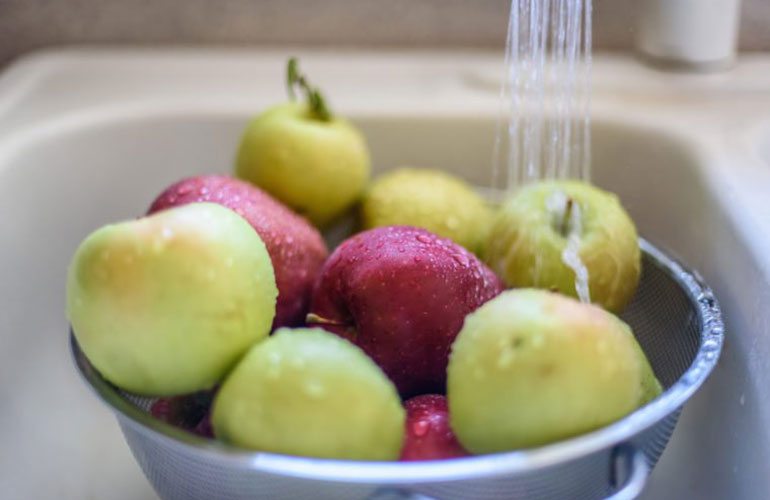 Wash produce in a colander