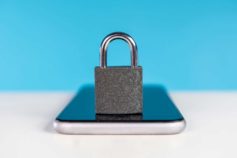 padlock sitting on smartphone