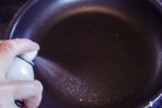cooking oil being sprayed in frying pay