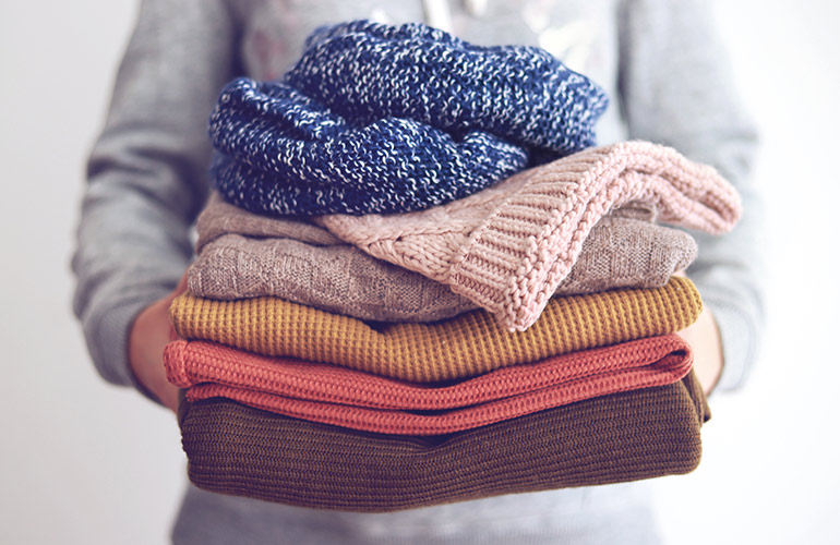 Use a pillowcase to store your jumpers