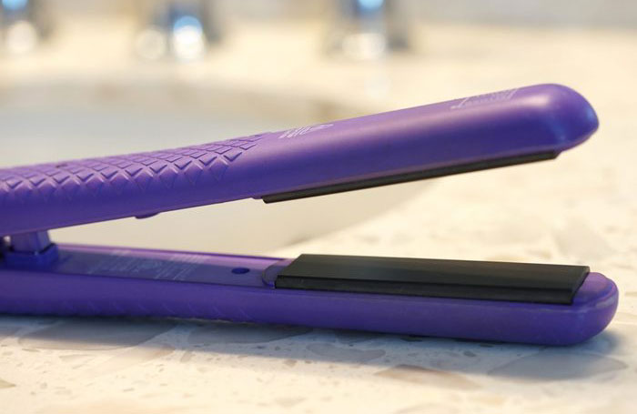 Use a hair straightener to unwrinkle clothing