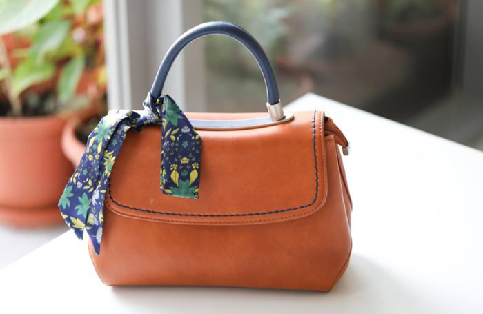 Placing her handbag on the table