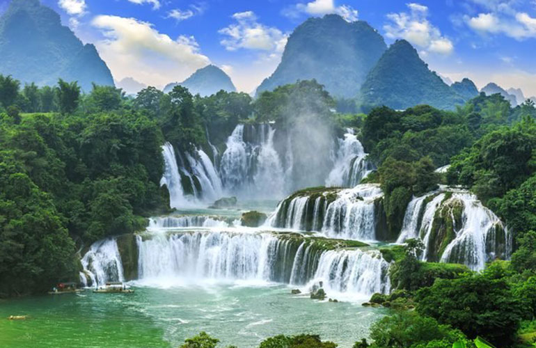 A waterfall watched over by Buddha
