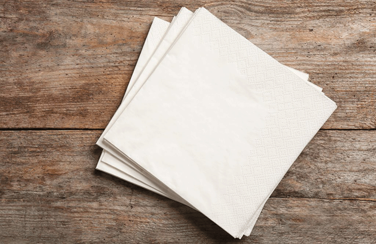 Using beverage napkins to clean up a spill