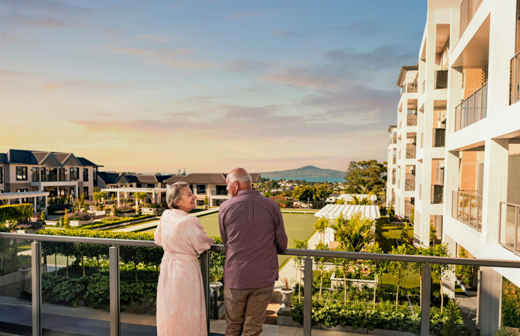 A couple standing in the garden of a modern-designed SummerSet Retirement Village