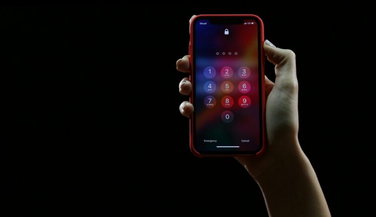 a hand holding a phone showing the passcode screen