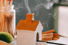 A miniature house with aromatic smoke rising from the chimney