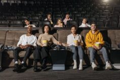 A group of young people watching a movie at the cinema