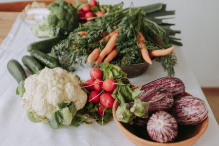 Fresh cauliflower, carrots, radishes, cucumbers and eggplants.
